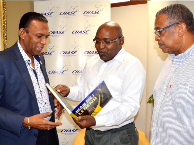 The CHASE Fund contributed $2.5 million to the publication of the book “Usain Bolt: Legend” The book was produced in partnership with the Gleaner Company and Ian Randle Publishers.  A copy of the book was presented to the CEO, W. Billy Heaven on June 8, 2017 by Garfield Grandison, Gleaner Editor.  (L-R) W. Billy Heaven, CEO, CHASE; Garfield Grandison, Gleaner Editor; and Ian Randle of Ian Randle Publishers.