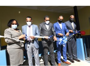 Minister of State in the Ministry of Education, Youth and Information, Hon. Robert Nesta Morgan (centre), cuts the ribbon to officially open the Bethlehem Moravian College Early Childhood Centre of Excellence with the help of (L-R) acting Principal of the Bethlehem Moravian College, Dr Andrea Wilson; Chief Executive Officer of the CHASE Fund, W. Billy Heaven; Chairman of the Board at CHASE Fund, Omar Frith; and Chairman of the Bethlehem Moravian College Board of Management, Lowel G. Morgan. The Centre of Excellence was officially opened on December 6, 2021 in Malvern, St. Elizabeth.