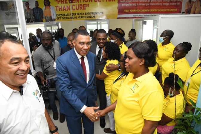 Prime Minister Andrew Holness, and Minister of Health and Wellness, Christopher Tufton (l), greets staff of the Chapelton Community Hospital after the hospital was reopened on December 6, 2022.